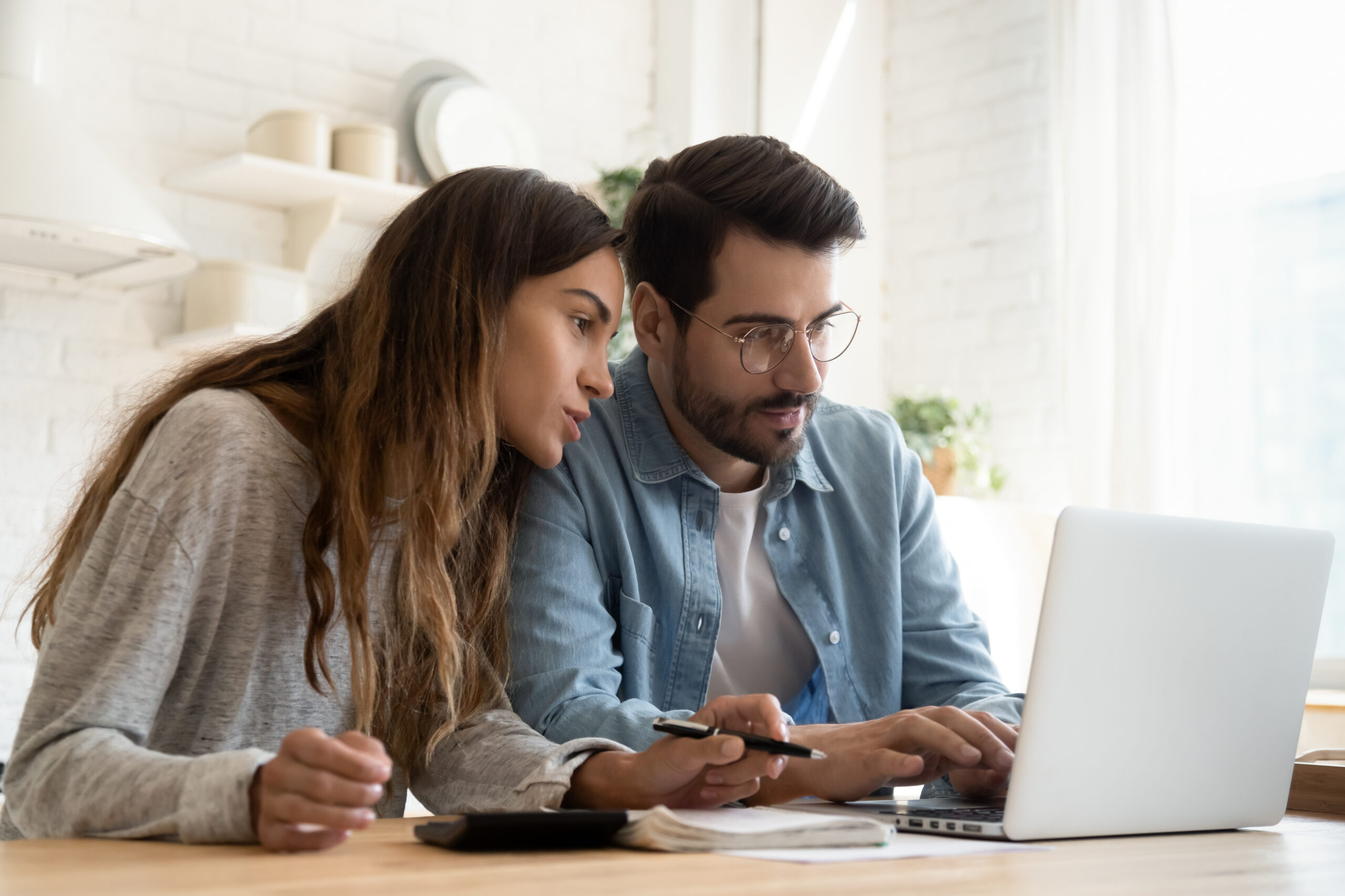 young couple discusses finances with computer | Discounted cycles for qualifying patients | TRM | Chattanooga