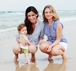 LGBT Fertility Couple on the beach with baby