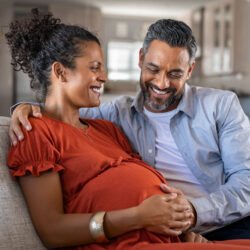 Happy mid adult couple caressing mom's pregnant belly | Tennessee Reproductive Medicine