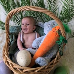 Happy baby in a basket with stuffed animals | Conceived with the help of Tennessee Reproductive Medicine in Chattanooga rather than a Nashville fertility clinic