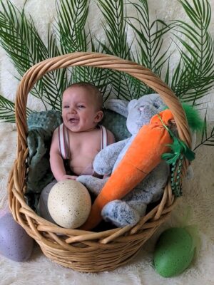 Happy baby in a basket with stuffed animals | Conceived with the help of Tennessee Reproductive Medicine in Chattanooga rather than a Nashville fertility clinic