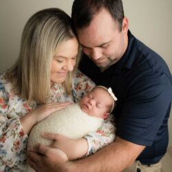 Carrie & Trent holding Harper Ann after their journey TTC | Tennessee Reproductive Medicine | Chattanooga
