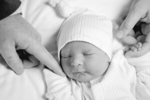 Henry, conceived with the use of letrozole, holds hands with his parents | Tennessee Reproductive Medicine | Chattanooga